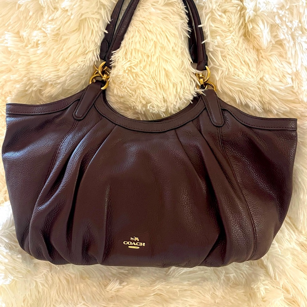 Beautiful pre loved Leather Coach Medium size handbag. Color is dark burgundy.